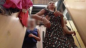 My stepmother helps me dress my naked body in a public fitting room.