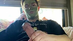 Fit guy strokes his cock while doing skin care routine