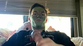 Fit guy strokes his cock while doing skin care routine