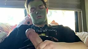 Fit guy strokes his cock while doing skin care routine