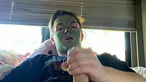 Fit guy strokes his cock while doing skin care routine