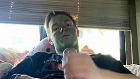 Fit guy strokes his cock while doing skin care routine