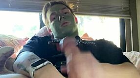 Fit guy strokes his cock while doing skin care routine