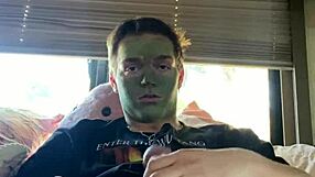 Fit guy strokes his cock while doing skin care routine