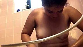 She's shaving her hairy bush in the shower.