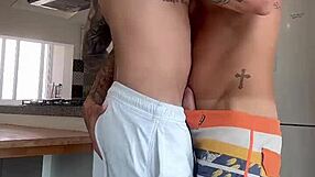 Gay blowjob and handjob action in the kitchen