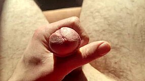 close up of edging from flaccid, playing with precum in natural light