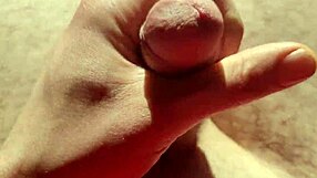 close up of edging from flaccid, playing with precum in natural light