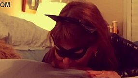 A mature woman in cosplay of Catwoman gives a deep blow job to Batman