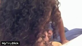 A beautiful black girl with natural breasts gives a good blow job to a small penis