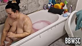 A pervert watches a busty BBW wash her big boobs in the bathtub
