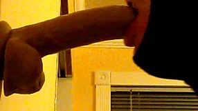 Gay guy in hood practices deepthroating a big dildo passionately