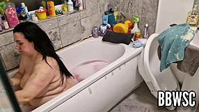 A pervert watches a busty BBW wash her big boobs in the bathtub