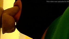 Gay guy in hood practices deepthroating a big dildo passionately