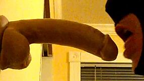 Gay guy in hood practices deepthroating a big dildo passionately