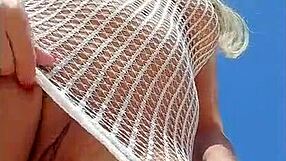 Young blonde’s transparent dress makes her almost naked outdoors