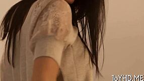 Young woman engages in intimate activity with partner in seductive manner