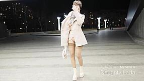A woman in a coat with nothing on under it standing outside