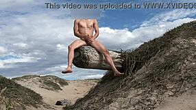 Nude athletic teasing with cock at public beach