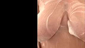 French mom caresses big tits in secret shower.