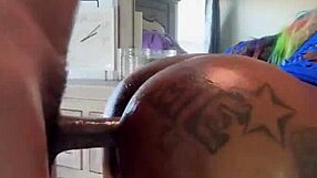 an ebony girl bends over, gagging on a big black cock until cumshot.