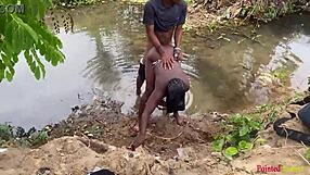 Outdoor babe enjoys black cock fucking in the garden river yard.