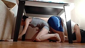 we sneak under the desk to rub our pussies while hiding from stepmother