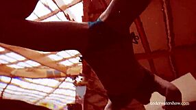 Martina wears a blue bikini in the underwater shower at the beach