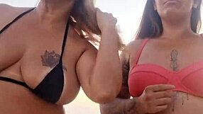 chatting dirty on beach with naughty friend before deflowering newbie