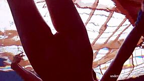 Martina wears a blue bikini in the underwater shower at the beach