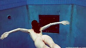 Martina wears a blue bikini in the underwater shower at the beach