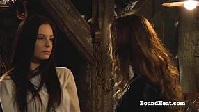 Busty lesbian in slave outfit gets touched and fingered by a domineering madame