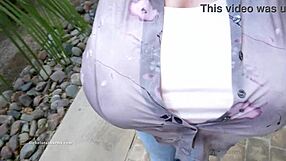 Chelsea Charms pops one button, revealing massive fake tits for the camera.