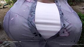 Chelsea Charms pops one button, revealing massive fake tits for the camera.