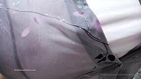 Chelsea Charms pops one button, revealing massive fake tits for the camera.