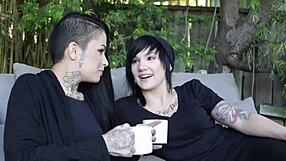 Tattooed lesbians engage in intense girl on girl action with passionate kissing