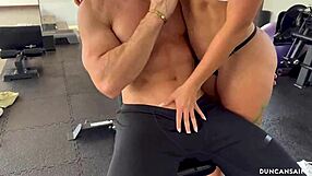 athletic latina and bodybuilder train alone in empty gym