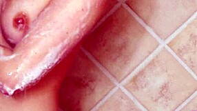 Gorgeous blonde enjoys a relaxing shower on the sofa