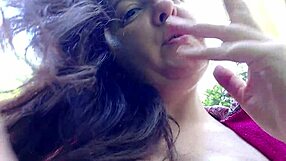 Nicoletta smokes in a public garden and shows you her big tits by pulling them out of her shirt