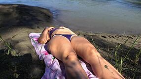 Watching a hairy pussy outdoors milf in a swimsuit sunbathing by the river amateur