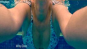 Preview of wife swimming in hotel pool wearing hot one piece swimsuit