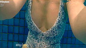 Preview of wife swimming in hotel pool wearing hot one piece swimsuit