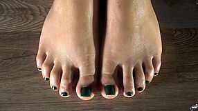 Close up of my oiled latina toes with green nails for your fetish pleasure