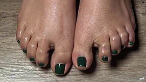 Close up of my oiled latina toes with green nails for your fetish pleasure