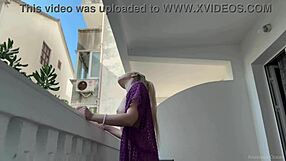 the blonde beauty strips naked on the balcony, flashing big tits and shaved pussy