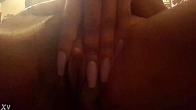 In this close-up solo scene, the pretty ebony woman with big clit masturbates by fingering her pussy