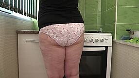 Home camera captures curvy mature milf cleaning in panties, showcasing big ass backstage