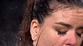 hogtied brunette woman experiences water bondage in a fetish scene