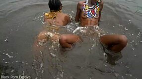 two lesbians bathe together in village river