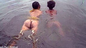 two lesbians bathe together in village river